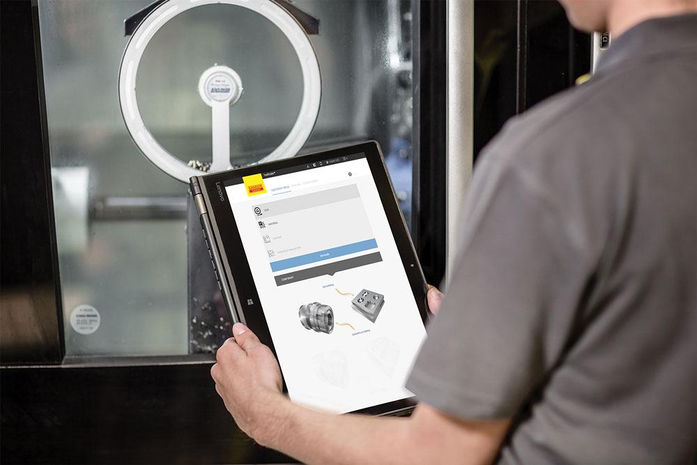 Operator with tabletshowing CoroPlus ToolGuide software from Sandvik Coromant.