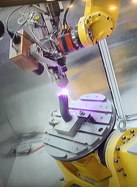 Laser Directed Energy Deposition of a pipe without support structures using a Fanuc 6-axis robot. Image courtesy of MSAM of the University of Waterloo.