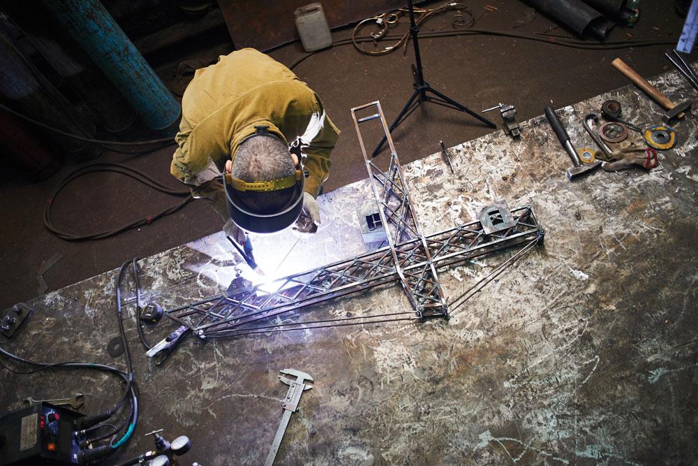 Welder working on a component