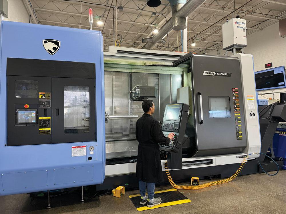 An operator works at a CNC machine at Optima.
