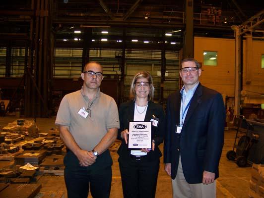 Mary Haurilak accepts plaque for CIM Leadership Summit