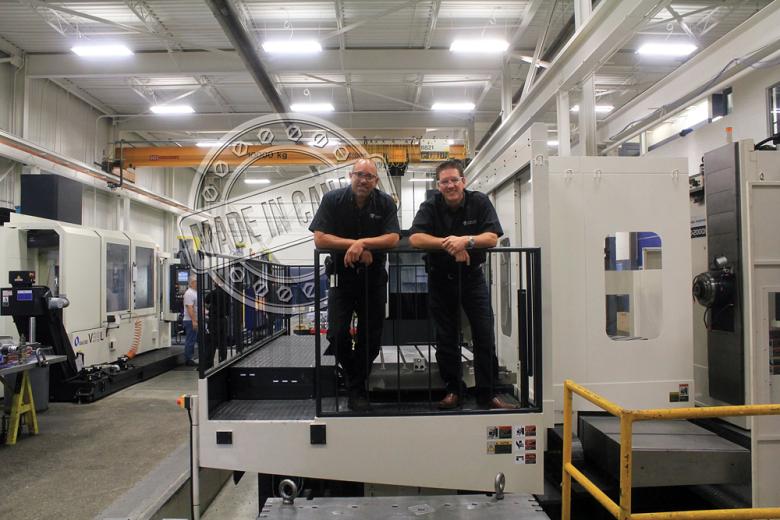 Brian Bendig and Mike McNaughton stand on a machine access platform