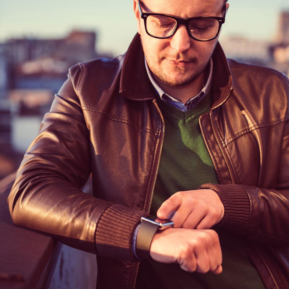 Photos of man checking data on smart watch.