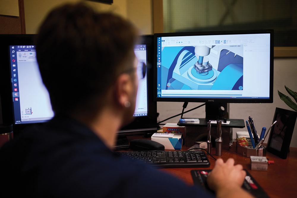 A CNC programmer works at Big Drum Precision Machining and Automation.