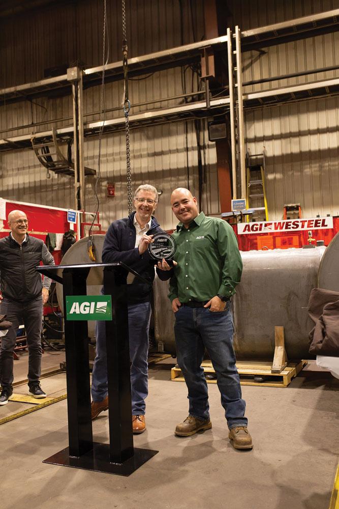 (From left) Paul Householder, AGI president and CEO, presents Steve Ricklefs, AGI Olds plant manager, with an award. 