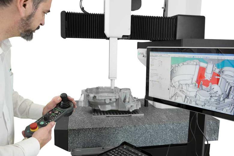 Operator checking dimensions on CMM.