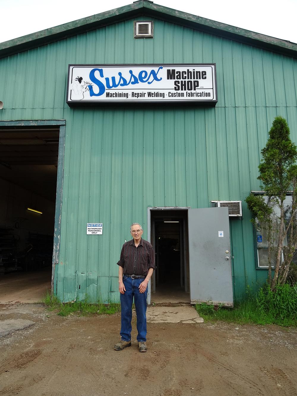 Don Nancekivell, the owner of Sussex Machine Shop, stands in front of the shop he founded in 1978.