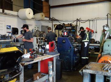 Ace Machining workers using manual machines to
work on custom projects that come into the shop.