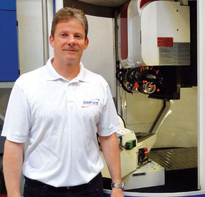Marke Fox, president of
Sharp-Rite Tooling and
Manufacturing, with the
company&rsquo;s newer Walter Helitronic Power tool grinding machine.