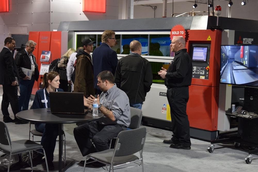 FABTECH Canada attendees check out the newest Mitsubishi fiber laser in the MC Machinery booth. 