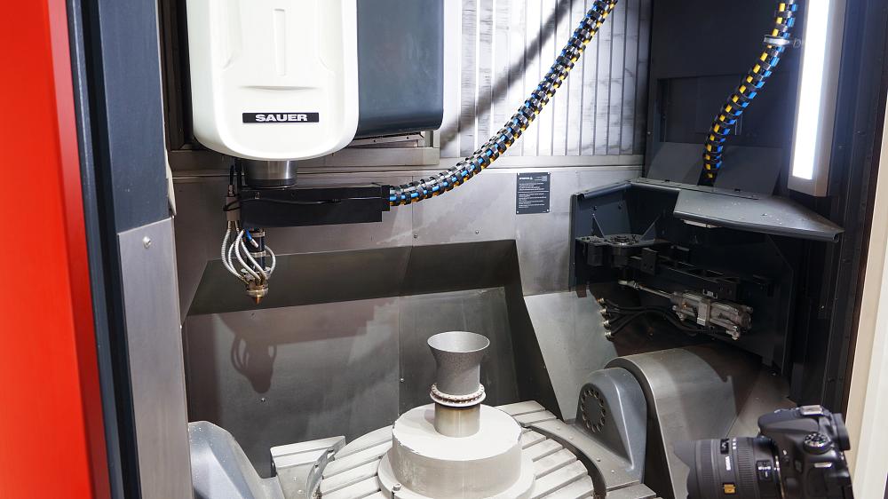 Laser metal deposition for additive manufacturing meets conventional metal cutting subtractive manufacturing on the same machine, run entirely by a single CNC in an inert atmosphere.  