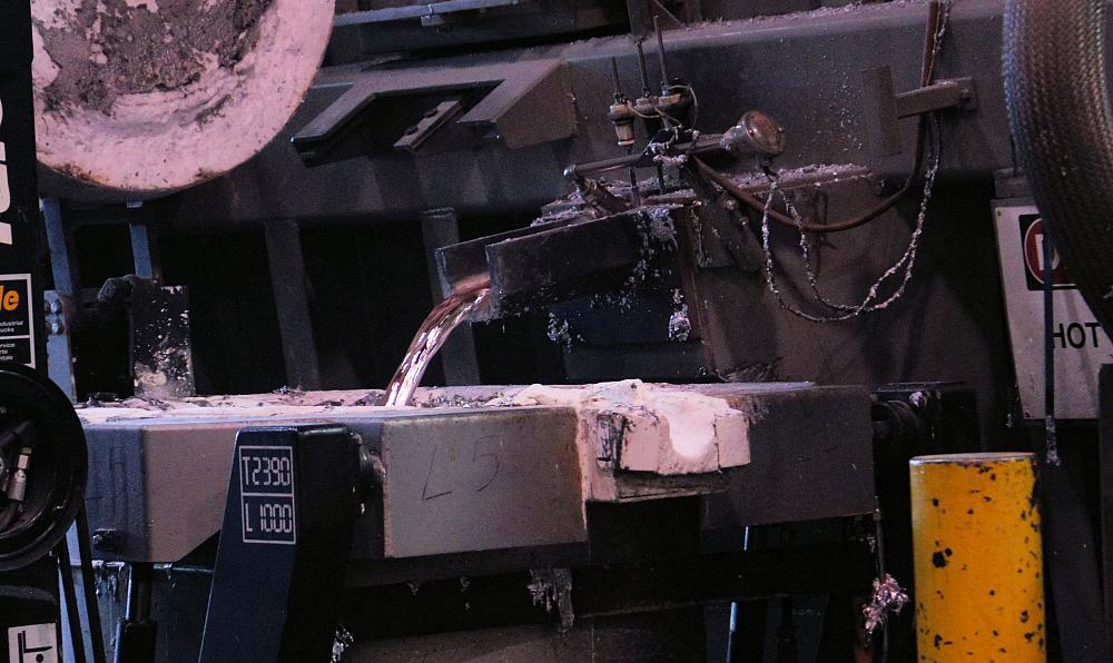 Molten aluminum alloy is poured into a crucible before being delivered to a casting machine. 
