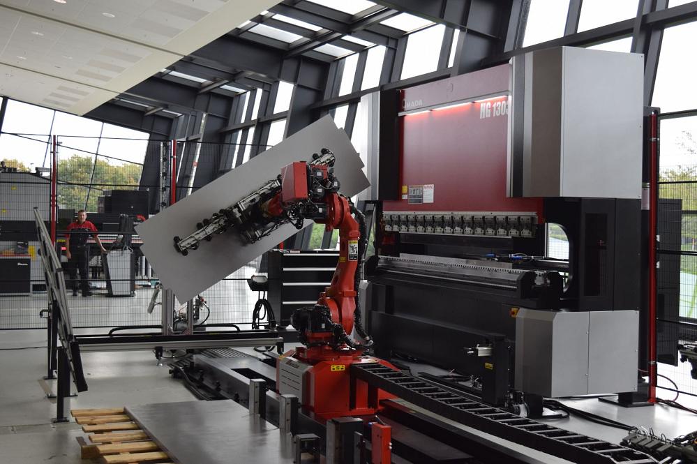 The HG1303 RM robotic compact bending system lifting a sheet into place for a bending operation. The bending robot can handle parts up to 176 lbs. and sheet sizes up to 8.20 ft. by 4.10 ft. 