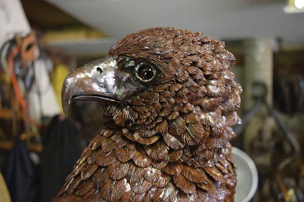 This is a Bateleur eagle, native to South Africa. Baker captures the bird as life-like as he has by cutting and etching each feather individually. The patina is created with the use of a chemical spray. 