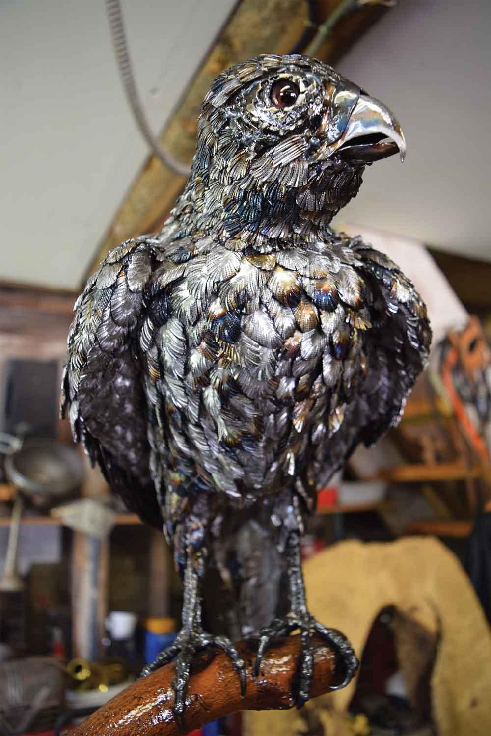 For this peregrine falcon, Baker was able to suggest the variation in the plumage on the bird's breast by using stainless steel for some of the feathers.