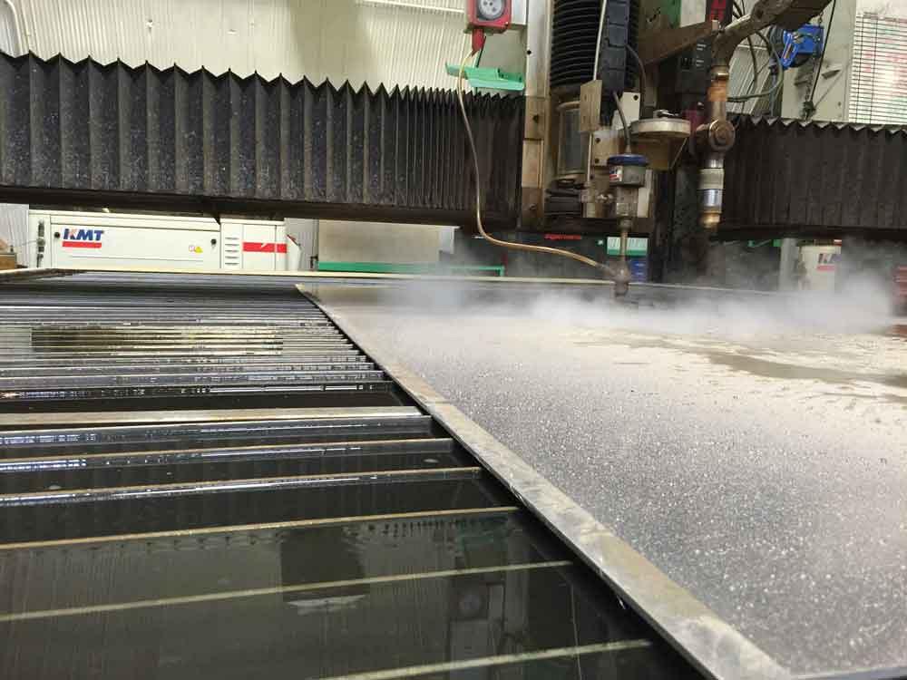 The waterjet cutting system in action on the Machitech combination table.
