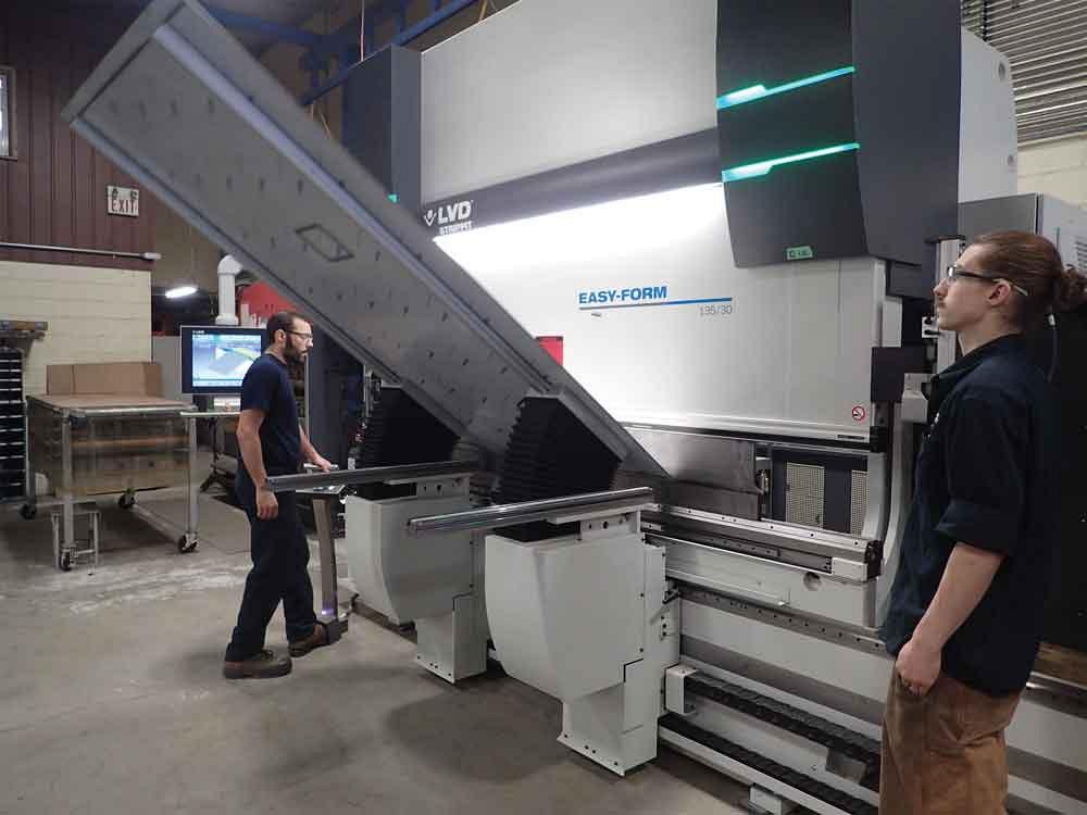 Bending a long piece of sheet metal with the help of lifters on the LVD Strippit PPEB press brake at Pure Ingenuity. 